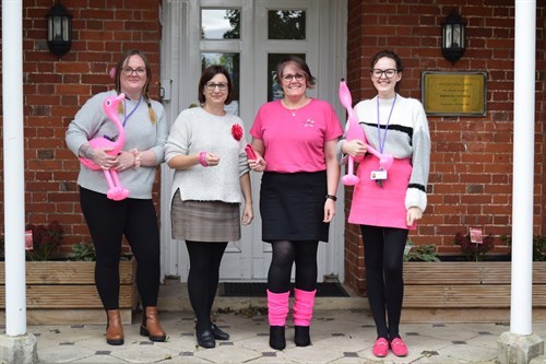 Staff With Pink Outfits And Flamingos