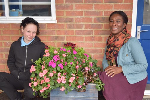 Student And Staff With Pink Flowers