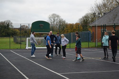 Group Of Students And Staff Doing Activities Outside