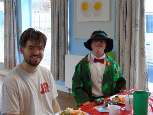 Two Male Students Enjoying Their Christmas Dinner