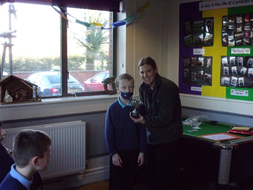 Staff And Student Holding Trophy