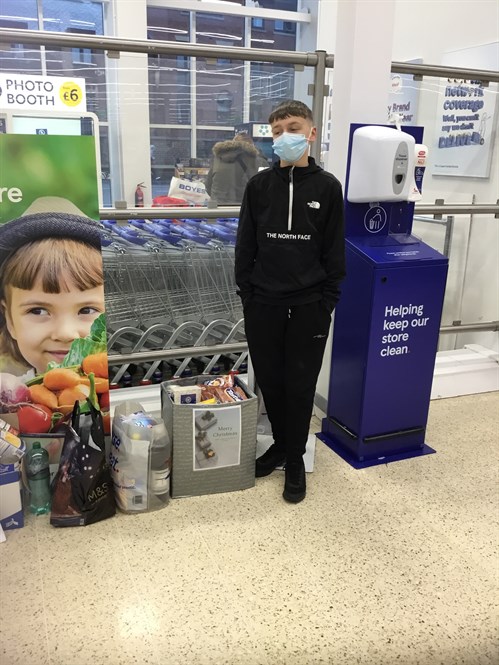 Male Student Stood By Food Bank