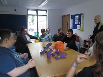 Group Of Students Playing Table Bowling