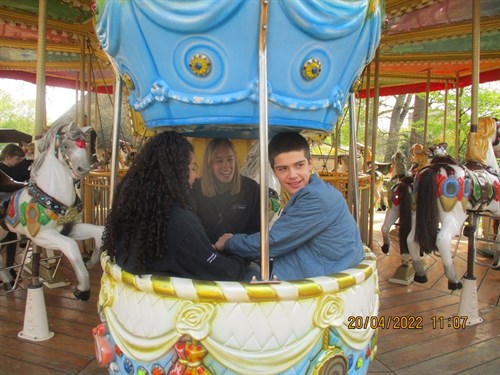 Male Student And Staff Smiling On Fair Ride
