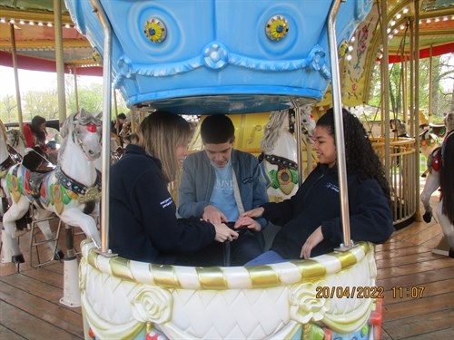 Student And Staff On Funfair Ride
