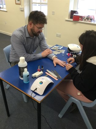 Dan Getting Nails Done By Student