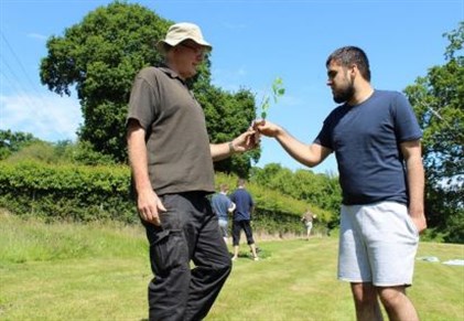 Queens Green Canopy Student And Staff Holding Tree To Be Planted