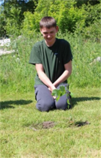 Invest In Our Planet Student Planting Tree