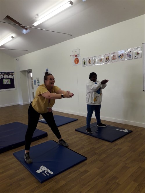 Staff And Student Doing Yoga