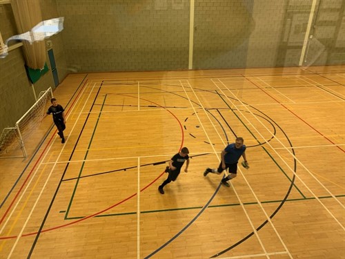Student And Staff Running In Sports Centre