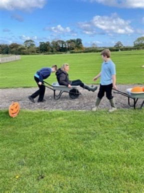 Students Having Fun Pumpkin Picking