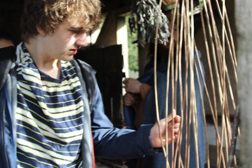Student Touching Artefacts In The Iron Age Roundhouse