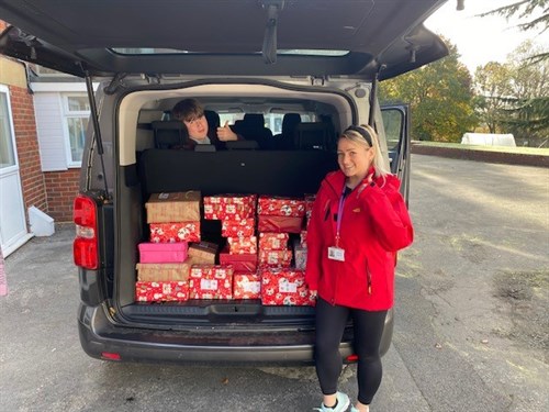 Xmas Boxes Iin Car Boot With Female Staff Member And Student