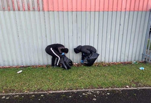 Hartlepool Two Male Students Cleaning The Rubbish
