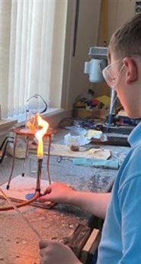 Science Student With Bunsen Burner
