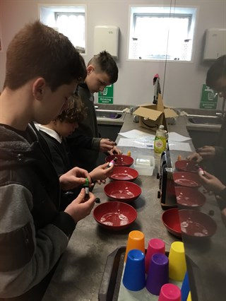 Group Of Male Students Making Soap On Science Day
