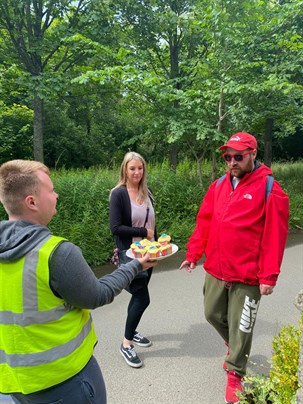 CHOW Young Person Handing Out Cakes