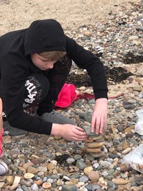Exam Season Treat Student Balancing Stones On Beach