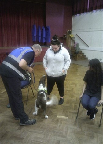 Dog Handling Student Hiding Item From Sniffer Dog