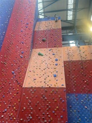 Sunderland Climbing Wall Student At Top Of Large Wall