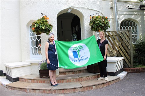Staff Holding Eco School Green Flag