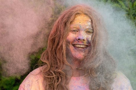 Grateley Female Student Smiling In Paint Powder Activity