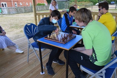 GHS Chess Tournament Students Mid Game Outside