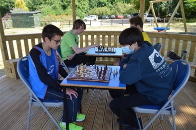 GHS Chess Tournament Students Playing Chess Outside