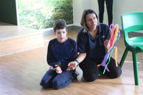 Music For Autism Male Student With Staff Member Taking Part