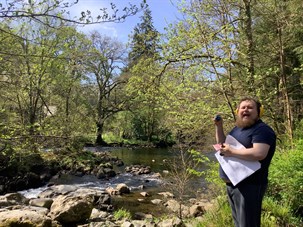 Student By A Stream