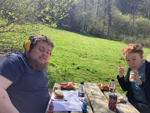 Students Eating Lunch On A Bench