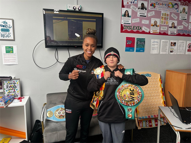 Natasha Jonas And Young Person Holding Belts
