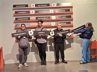 Young People And Staff Holding Signs