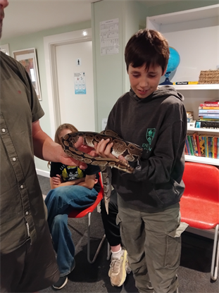 Young Boy Holding Snake